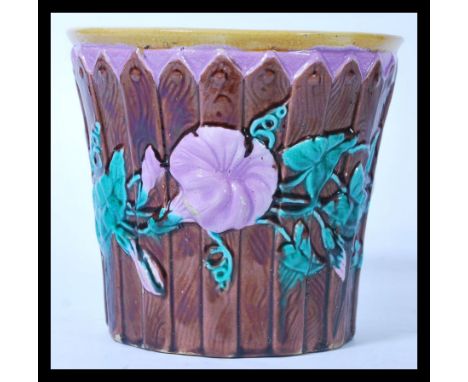 A 19th Century Victorian Majolica Jardiniere / planter, having a pink interior, and a raised fence design to the sides with f