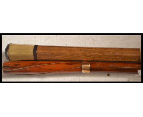 A pair of early 20th century Edwardian walking stick canes one having a tapering bamboo shaft with 9ct gold (unmarked but mak