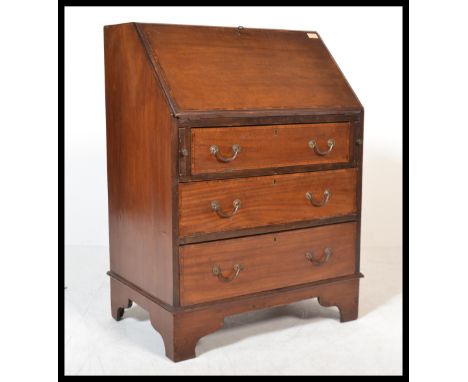 An Edwardian mahogany bureau being raised on bracket feet with a bank of drawers having appointed bureau atop