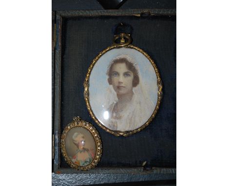 An early 20th Century hand painted watercolour portrait painting miniature depicting a lady in wedding dress with veil comple