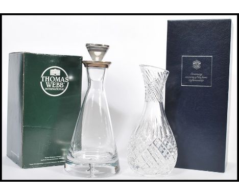 A boxed Thomas Webb clear glass decanter of tapering form having a silver hallmarked collar and stopper. Hallmarked Birmingha