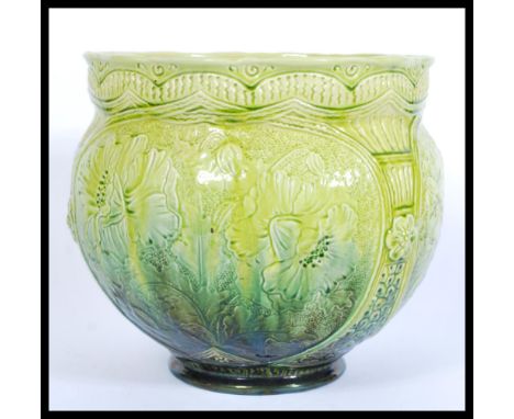 A late 19th century turquoise Burmantofts faience art pottery planter jardiniere vase having engraved floral patterning. Rais