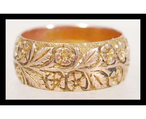 A 19th Century Victorian hallmarked 9ct gold band ring with engraved with floral detailing. Hallmarked for Birmingham 1898. T