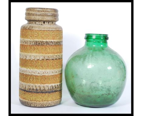 A West German ceramic stick stand with embossed patterning to the sides along with a green glass bottle / carboy. Tallest 48c