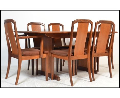 A 1970's retro teak wood dining room suite comprising a set of 6 dining chairs and an extending dining table. The table being