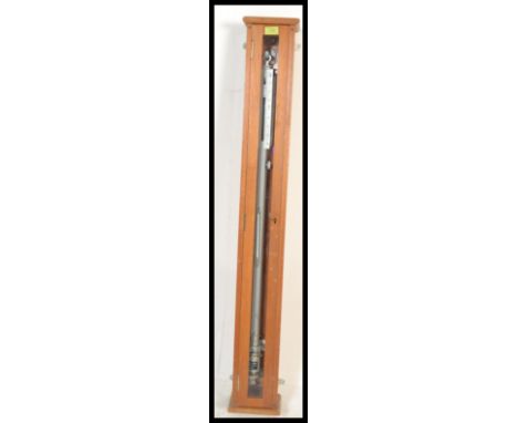 A vintage mid 20th Century cased ships cased maritime ships barometer, the barometer set to a gimble and weighted, in the man