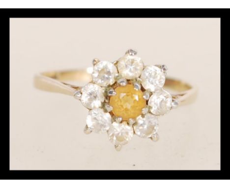 A hallmarked 9ct gold ring set with a central yellow stone flanked by white stones. Hallmarked Birmingham. Weight 2.0g. Size 