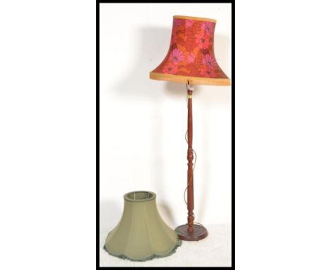 A vintage retro standard lamp having a wooden reeded stand with a 1960's retro shade white a red and orange floral pattern an