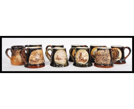 A selection of nine mid century Great Yarmouth pottery ceramic steins / tankards most having brown glaze with scenic panels t