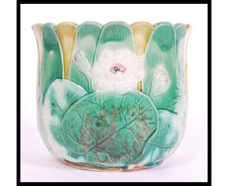 A 19th century Victorian majolica planter in the manner of George Jones having blue glaze interior with relief green decorati