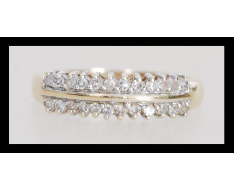 A 9k 9ct gold ring set with two rows of diamonds. Diamond of approx 25pts. Weighs 1.8 grams size O.