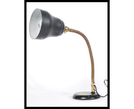 A vintage retro 20th Century industrial anglepoise desk lamp raised on a circular base with brass gooseneck and black enamel 