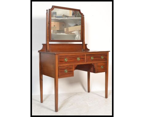 A&nbsp; late 19th century satinwood dressing table by Shoolbred of London with swing mirror over an arrangement of four drawe