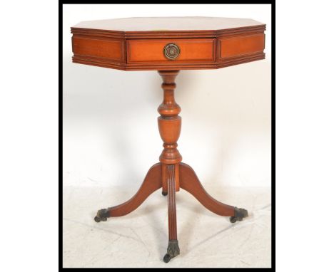 A Regency revival yew wood octagonal pedestal drum table of good quality being raised on castor splayed legs with baluster co