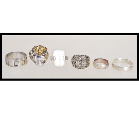 A group of sterling silver 925 to include a lion head ring with citrine stone mane, marcasite ring, band ring with square des