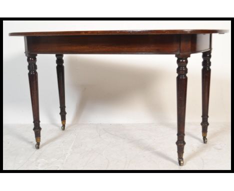 A 19th century George III mahogany d-end demi-lune console table being raised on turned legs with fitted frieze and shaped to