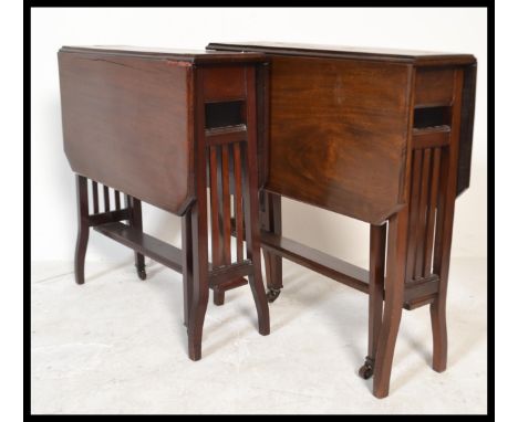 A near pair of Edwardian mahogany Sutherland table / tables being raised on squared legs with railed centres having drop leav