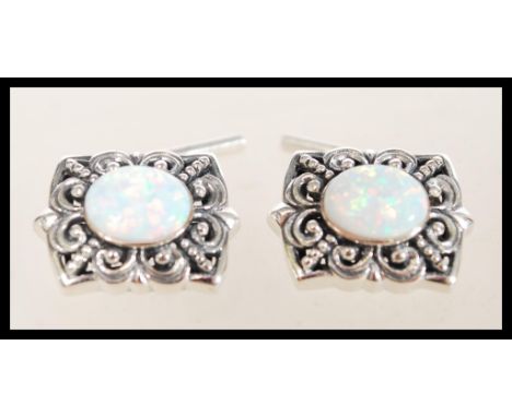 A pair of sterling silver cufflinks having large central opal panels. Weighs 10.1 grams.