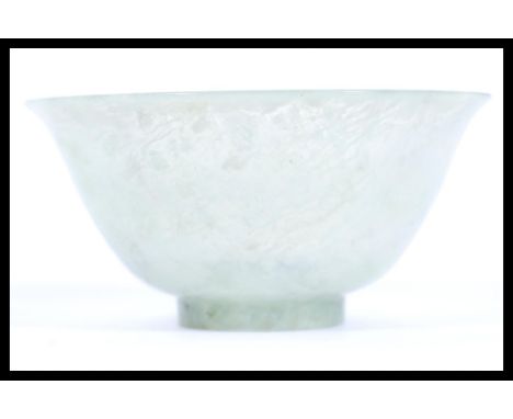 A 19th Century Chinese jade tea cup bowl of conical form having a mottled green jade colourway. Measures 5cm high 10cm diamet