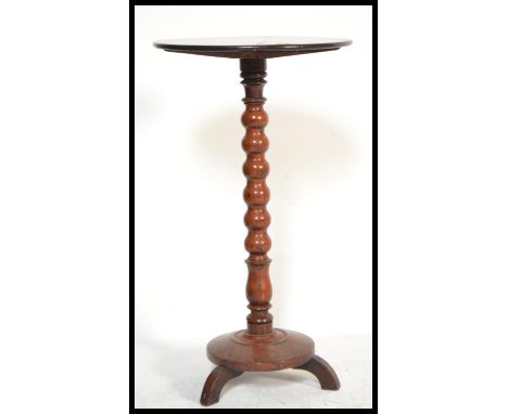 A 19th century mahogany wine table / barley twist plant stand. Raised over a terraced base with circular top above. Measures: