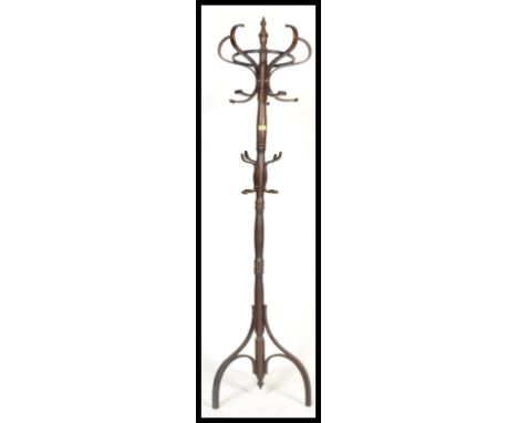 A vintage 20th century Thonet style bentwood hat stand being raised on splayed legs with s-shaped hooks atop. 183cm high