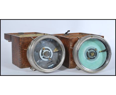 A pair of oak cased vintage 20th Century Pigeon clocks, both clocks housed in chrome cases, one with applied makers label to 