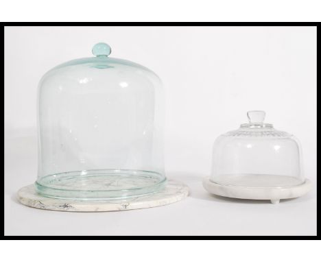 A collection of 2 vintage 20th century glass cloche's of varying sizes, each of bell form with pommel handle tops. Biggest 29