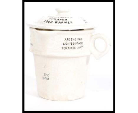 A ceramic vintage 20th century Clarke's Pyramid food warmer of white glaze with black notation being marked to the base. Meas
