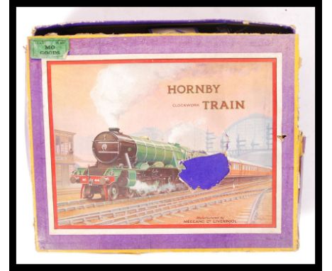 A vintage Hornby Series made 00 Gauge model railway Clockwork Train set MO Goods to include; a tin plate locomotive, 3 x wago