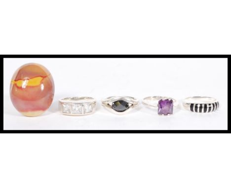 A selection of stamped 925 silver rings to include a split band ring with a large agate oval stone, a ring set with three squ