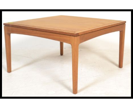 A vintage retro 20th Century teak wood coffee table by Legate raised on square tapering legs. Makers label to underside.&nbsp