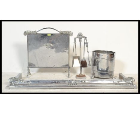 A 1930's Art Deco chrome fireside suite comprising fire fenderkerb, coal bucket,&nbsp; fire screen and companion set on stand