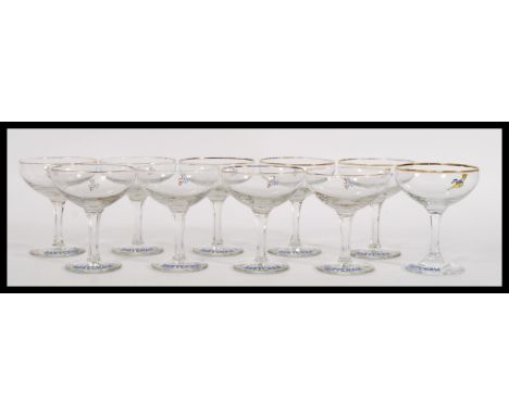 A set of ten vintage retro 20th Century Babycham glasses raised on circular bases with gilt rim and featuring the iconic Baby