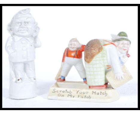 A late 19th / early 20th Century novelty German ceramic match strike, the match strike featuring a country bumpkin bent over 