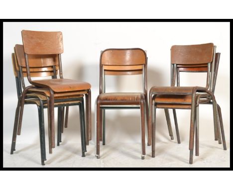A collection of vintage retro 20th Century stacking chairs of tubular form having wooden panel seats and backs.