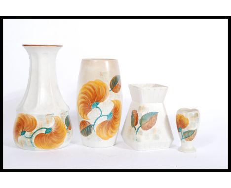 A collection of E Radford 1930's Art Deco ceramics in ' Wood's ' pattern. To include a tall vase, cylindrical vase, angled va