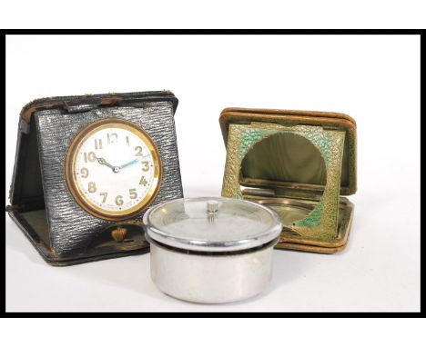 Two vintage 20th Century leather pocket watch travelling cases one being green leather and the other black, the black case in