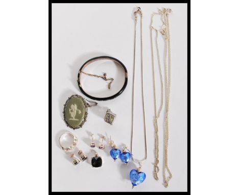 A selection of silver jewellery to include a stamped 925 silver necklace with a heart shaped glass pendant and matching earri