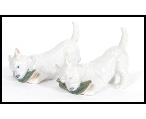 A pair of Royal Copenhagen ceramic dog figurines depicting west highland terrier and slipper model 3476. Printed and painted 