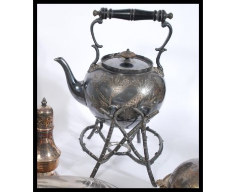 A large collection of silver plate items from the 19th and 20th century to include a spirit burner, centrepiece, candlesticks