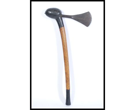 A vintage 20th Century African tribal hand axe with a shaped blade and turned stem with ebonised sections and bulbous top, th