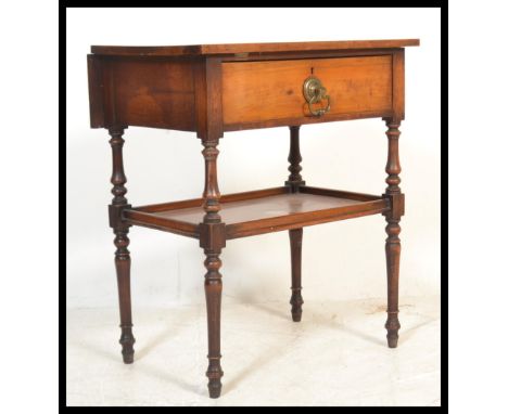 A Victorian mahogany side / lamp table being raised on turned legs with lower tier under single drawer.&nbsp;Measures: 72cm h