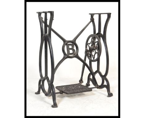 A Victorian mahogany and cast iron Singer sewing machine treadle table base having an excellent and unusual cast iron design,