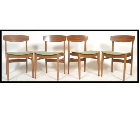 A set of four vintage retro 20th Century Remploy beech dining chairs raised on beech supports with tola wood veneer back rest