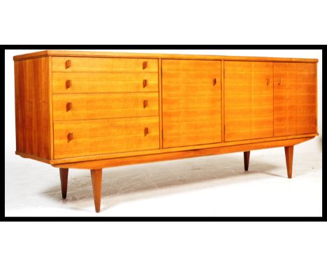 Alfred Cox - Heals - A rare 1960's retro vintage sycamore wood sideboard credenza comprising of having a bank of four graduat