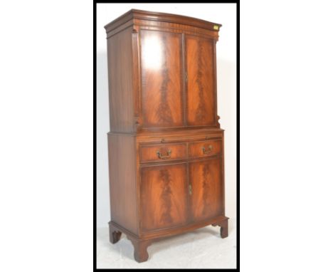 A Bevan and Funnell Reprodux&nbsp; flame mahogany four door bow fronted cocktail / drinks cabinet. Inset with&nbsp; glazed sh