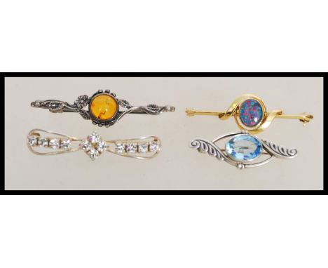 A group of four sterling silver and silver gilt bar brooches to include silver gilt brooch with opal panel, amber floral silv