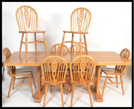 A 20th Century ash refectory dining table, raised on square pedestal supports united by central stretcher together with a set