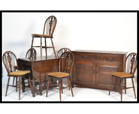 A Jaycee / Old Charm dining room suite comprising a set of 6 wheelback dining chairs, a drop leaf dining table and a sideboar