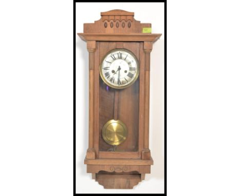 An early 20th Century Edwardian Vienna style oak cased wall clock, silvered dial, Roman numeral chapter ring, eight day movem